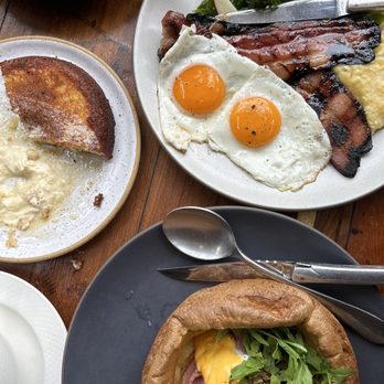 Manuela - Popover Benedict, Sweetheart Ham, Poached Egg, Hollandaise, Greens  Thick Cut Bacon, Pencil Cob Grits, Fried Egg, Sage Maple - New American Near Me - Los Angeles, California