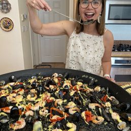 Having a spoon full of black squid ink paella. Having a spoon full of black squid ink paella.