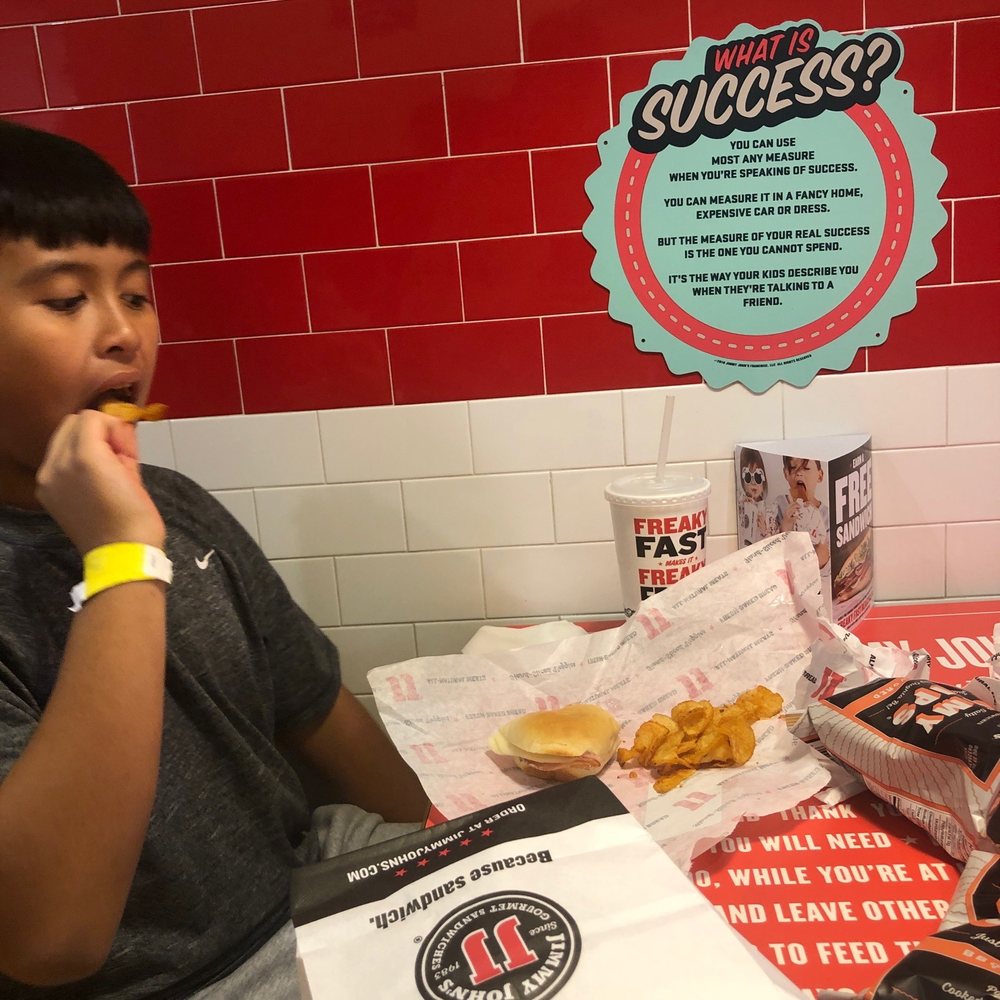 My brother eating a cold sub with bbq chips