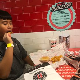 My brother eating a cold sub with bbq chips My brother eating a cold sub with bbq chips