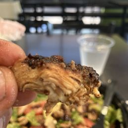 Overcooked dry burnt chicken in my small salad Overcooked dry burnt chicken in my small salad