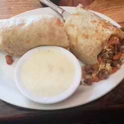 Los Ponchos Mexican Grill - California burrito - very filling and great with the queso poured over. Fork and knife burrito, it falls apart when you pick it up