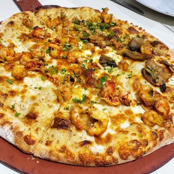 Reginelli's Pizzeria - Cajun Crawfish Pizza, found on their Mardi Gras Menu - Pizza Near Me - Metairie, Louisiana Reginelli's Pizzeria - Cajun Crawfish Pizza, found on their Mardi Gras Menu - Pizza Near Me - Metairie, Louisiana