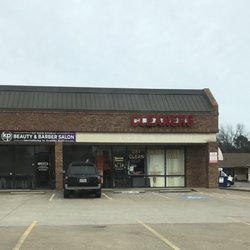 Butch Cleaners And Alterations - Light up 'Open' sign is off; however, a printed sign below it states open. Sweet woman working the register.