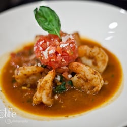 J. Gilbert's Wood-Fired Steaks & Seafood - The Shrimp Derango served with tomatoes, basil, spinach, ancho chile butter and parmigiano reggiano.