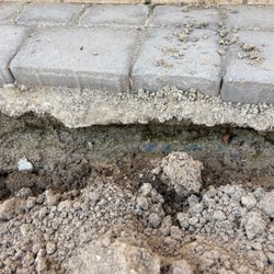 Rojas Landscaping - Moisture under the pavers. Enough that the landscaping fabric is dripping daily.