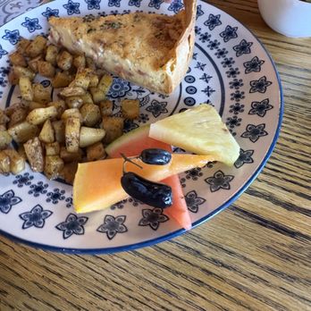 Cafe Mon Amour - Generous slice of quiche, served alongside a side of diced home fries (breakfast potatoes) and a small assortment of fresh seasonal fruit. - Coffee & Tea Near Me - Palm Springs, California Cafe Mon Amour - Generous slice of quiche, served alongside a side of diced home fries (breakfast potatoes) and a small assortment of fresh seasonal fruit. - Coffee & Tea Near Me - Palm Springs, California