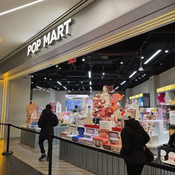 Pop Mart - store - POP MART store features a display of toys, decorations, and holiday-themed items inside, with two customers browsing. - Toy Stores Near Me - Flushing, New York