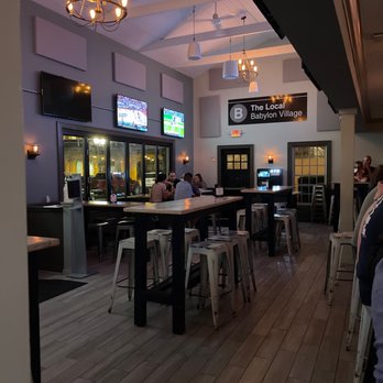 The Local - a restaurant with a long bar with stools - Cocktail Bars Near Me - Babylon, New York The Local - a restaurant with a long bar with stools - Cocktail Bars Near Me - Babylon, New York