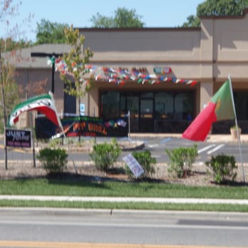 Fire Pit Grill - a fire hydrant and flags in front of a restaurant - Portuguese Near Me - Bayville, New Jersey