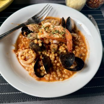 Carasau - Fregola Di Mare pearl pasta with clams, mussels, bay scallops, and shrimp, in a lobster broth and tomato sauce. SO delicious. - Sardinian Near Me - Culver City, California