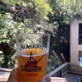The Asylum - a person holding a glass of beer - Pubs Near Me - Ketchikan, Alaska