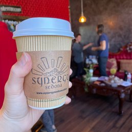 a hand holding a cup of coffee a hand holding a cup of coffee