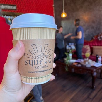 Synergy Cafe - a hand holding a cup of coffee - Coffee & Tea Near Me - Sedona, Arizona Synergy Cafe - a hand holding a cup of coffee - Coffee & Tea Near Me - Sedona, Arizona