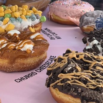 Voodoo Doughnut - The Grape Ape (top right) was a past favorite it looked sad and messy, just like the Homer next to it, so I didn't order it. - Donuts Near Me - Seattle, Washington Voodoo Doughnut - The Grape Ape (top right) was a past favorite it looked sad and messy, just like the Homer next to it, so I didn't order it. - Donuts Near Me - Seattle, Washington