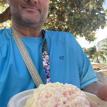 Hula  Dogs Shave Ice -  man holding a plate of food - Shaved Ice Near Me