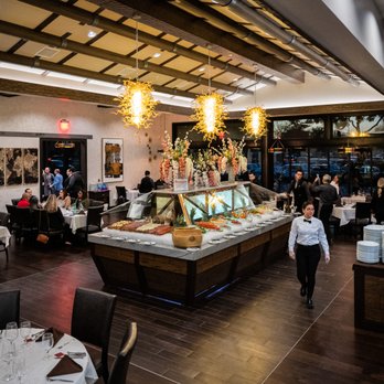 Brasão Brazilian Steakhouse - The main floor of our restaurant in Las Colinas is a spacious and elegant dining area that is sure to impress. - Steakhouses Near Me - Irving, Texas