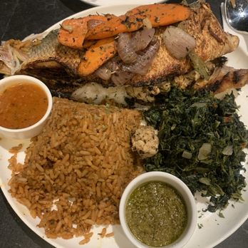 The Continent DC - Branzino with sautéed spinach, mixed vegetables and jollof rice. - African Near Me - Washington, DC, District of Columbia The Continent DC - Branzino with sautéed spinach, mixed vegetables and jollof rice. - African Near Me - Washington, DC, District of Columbia