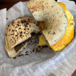 Bagelmania - Onion bagel with egg and scrapple Spinach and Herb Bagel with scrapple and eggs