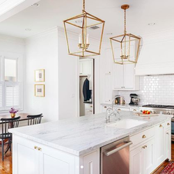 K&N Appliance Gallery - Icy white kitchen with gold accents by Aspire Fine Homes