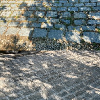 WB Paving - a cobblestone street with a tree in the background - General Contractors Near Me