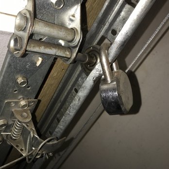 Valley Oak Property Management Turlock - lock from the prev tenant on the roll up garage door that took 3 months to have removed  to not have a lock on the garage door at all - Property Management Near Me - Modesto, California