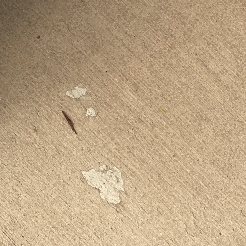 Chip in concrete supposed to be fixed with coating. Chip in concrete supposed to be fixed with coating.