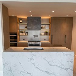 Bergen Marble and Granite - Bring warmth to your kitchen with brown cabinets and white countertops. A clean & modern look!