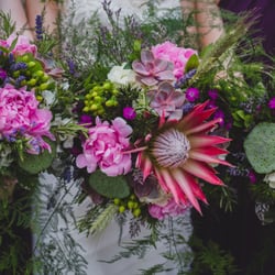Stunning wedding bouquets featuring an eye-catching and personally meaningful king protea.