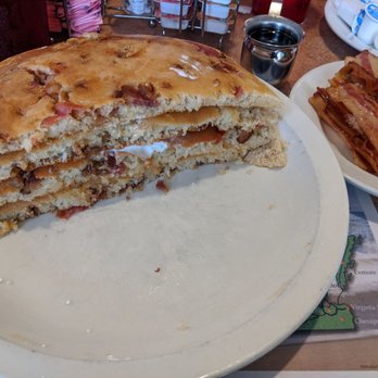 Astronomical Pancake House - Two Bacon Pancakes cut in half. ASTRONOMICAL is an understatement!!! - Breakfast & Brunch Near Me - Williamsburg, Virginia