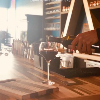 Xe 54 - a person pouring a glass of wine - Wine Bars Near Me - Neenah, Wisconsin Xe 54 - a person pouring a glass of wine - Wine Bars Near Me - Neenah, Wisconsin