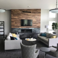 Lynden Interiors - Hardwood flooring used as a feature wall really sets this space apart.