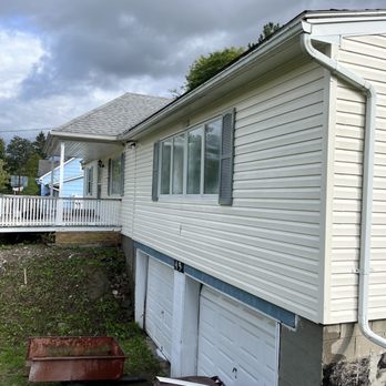 Skyroc Property Improvements - a garage with a wheelbarrow - Landscaping Near Me