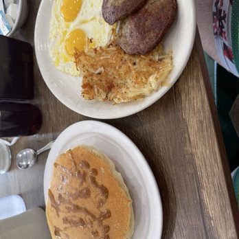 Bobbie's Southern Kitchen - Pancakes on a plate. A second plate with sunny side up eggs, hash browns, and 2 sausage patties. - American Near Me - San Antonio, Texas Bobbie's Southern Kitchen - Pancakes on a plate. A second plate with sunny side up eggs, hash browns, and 2 sausage patties. - American Near Me - San Antonio, Texas