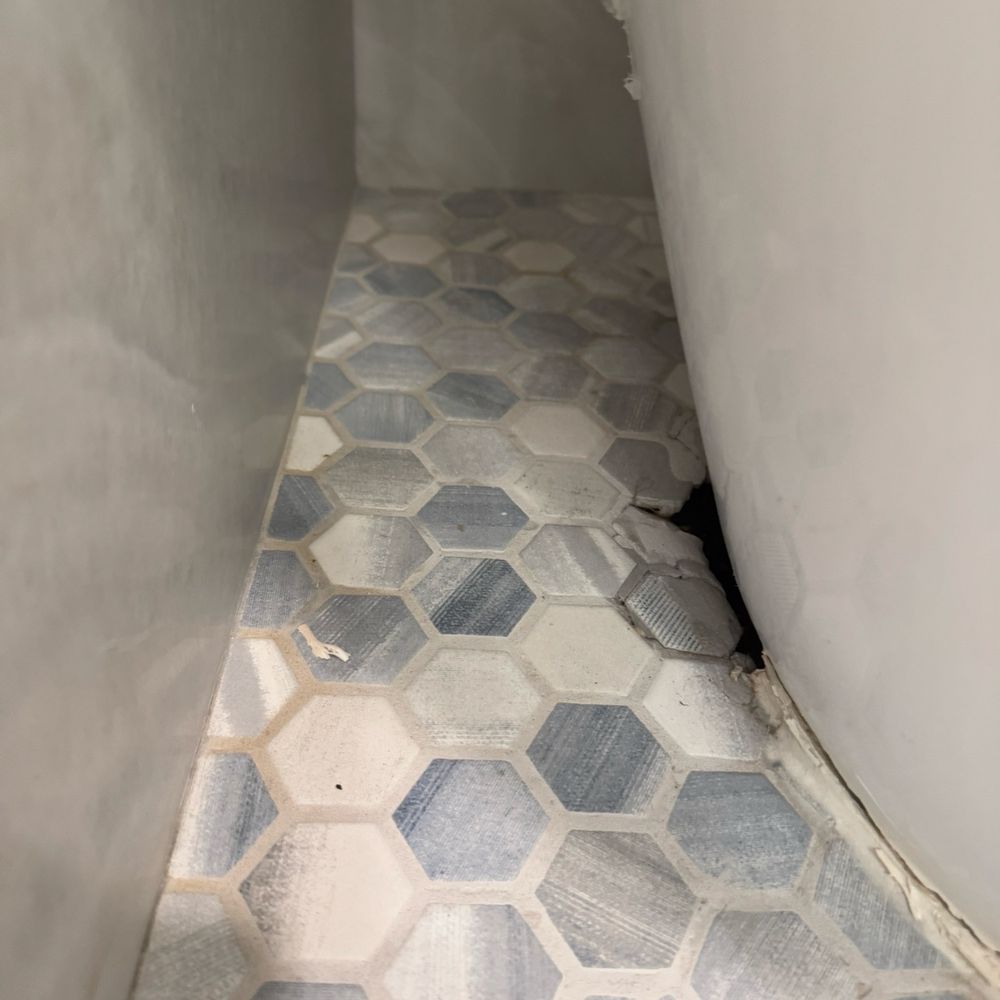 Tile guys left a hole where the drain is and it can be seen from outside. Tile guys left a hole where the drain is and it can be seen from outside.