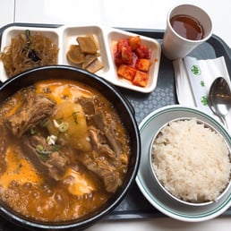 tray of food including rice, meat, and vegetables tray of food including rice, meat, and vegetables