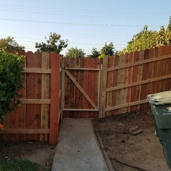 Kincaid Development - a fence with a gate and a trash can - General Contractors Near Me Kincaid Development - a fence with a gate and a trash can - General Contractors Near Me