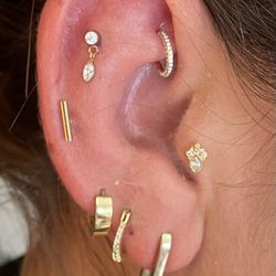 Karma Beverly Hills - Rook piercing done with small cz hoop. Flat piercing with dangle top