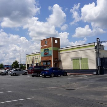 Captain D's - a parking lot with a clock tower - Seafood Near Me - Milledgeville, Georgia