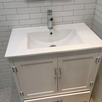 Finesse Builders - a bathroom with a sink and mirror - General Contractors Near Me - Jamaica, New York