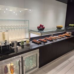 British Airways Lounge - Pastry, fruit, and beverage section.