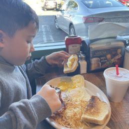 Kids 2 eggs, hash browns with bacon and toast.