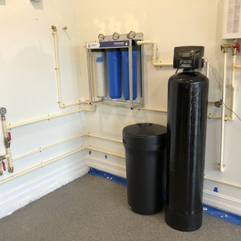 Next Level Plumbing, Water Heaters, and Sewer - Complete water filtration and tankless water heater installed in a garage. - Plumbing Near Me - Sarasota, Florida Next Level Plumbing, Water Heaters, and Sewer - Complete water filtration and tankless water heater installed in a garage. - Plumbing Near Me - Sarasota, Florida