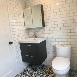 Mark's Carpentry - subway tiles modern bathroom, European style bathroom, tiles in whole bathroom wall, medicine cabinet storage, vintage floor tiles, black