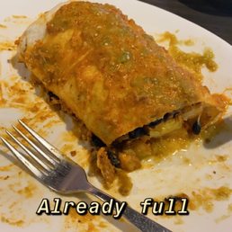 Breakfast burrito smothered in queso and salsa Breakfast burrito smothered in queso and salsa