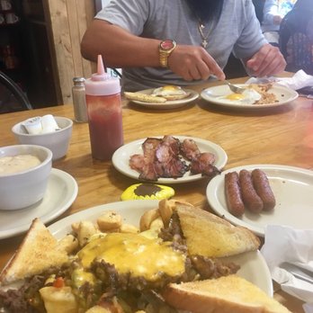 Southern Harmony Cafe - Ribeye skillet with white gravy. Sausage links and bacon (not mine, lol) eggs over easy hash browns and rye toast - Southern Near Me - Dade City, Florida