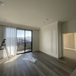an empty room with a ladder and a window