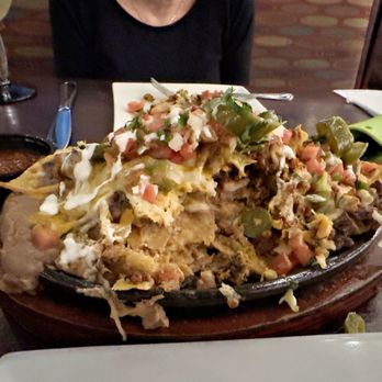 Tacos El Tio - Partway through the nachos. You can see how they have mixed the good stuff throughout. - Mexican Near Me - Harbor Township, New Jersey Tacos El Tio - Partway through the nachos. You can see how they have mixed the good stuff throughout. - Mexican Near Me - Harbor Township, New Jersey