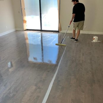 Performance Floors - a man mopping a hardwood floor - Flooring Near Me - Novato, California Performance Floors - a man mopping a hardwood floor - Flooring Near Me - Novato, California