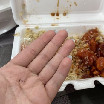 New China - a hand holding a container of food - Chinese Near Me - Xenia, Ohio New China - a hand holding a container of food - Chinese Near Me - Xenia, Ohio